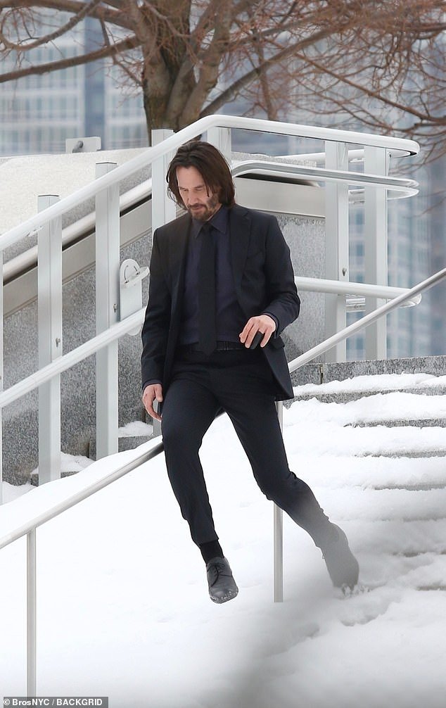 Having fun: The Matrix star appeared to have fun as he avoided the snowy stairs and smoothly slid down the hill on a rail instead