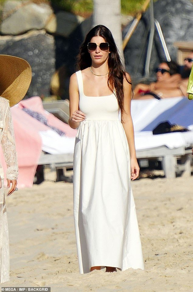 Stunning: Camila cut an elegant figure in a long white maxi beach dress. Featuring in a gathered waist, the skirt fell out in soft pleats