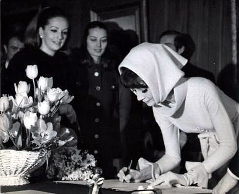Audrey Hepburn in an ensemble by Givenchy, signing the register at her wedding to Dr. Andrea Dotti. Witnessed by dear friends Doris Brynner and Capucine, at Morges, Switzerland, January 18th, 1969.