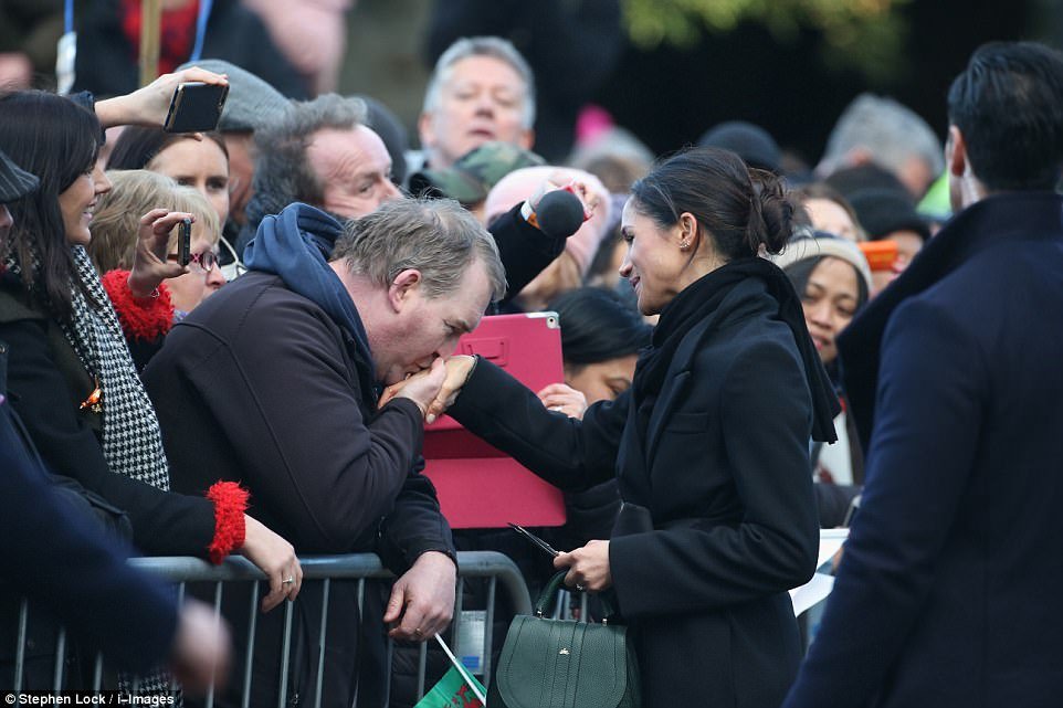 Meghan even allowed one fan to kiss her hand, as she conducted a long walkabout outside the castle