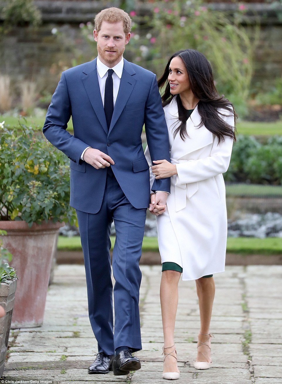 The bride-to-be looked stunning for the occasion in nude lace-up stilettos, an ivory winter coat and emerald dress. She wore her dark hair loose across her shoulders as she stood before members of the press 