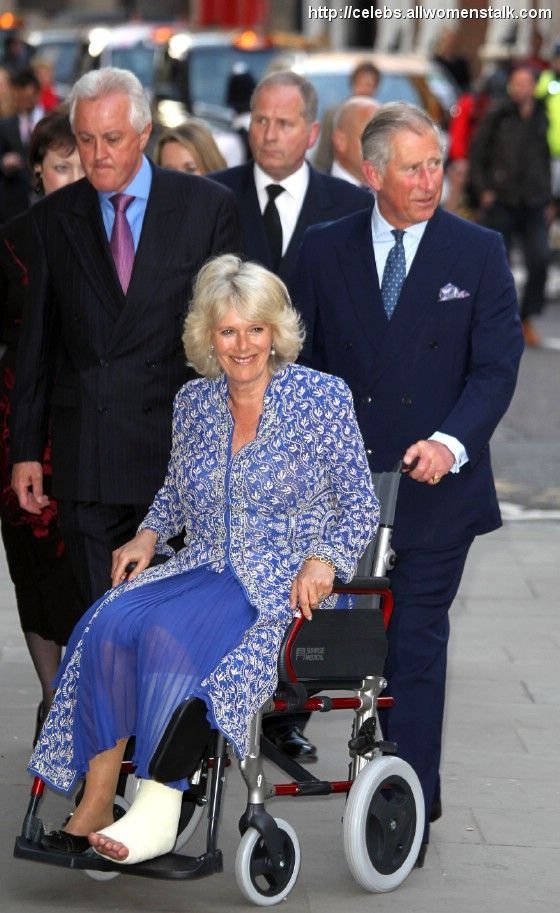 Prince Charles pushes his wife, Camilla Parker Bowles, in a wheelchair into the Royal Opera House. Camilla suffered a broken leg while vacationing in Scotland.
