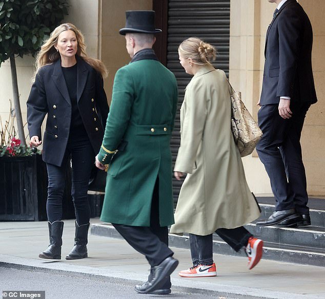Hello there: The supermodel was greeted by a friendly doorman while exiting the upmarket Mayfair address, a popular destination for visiting celebrities, accompanied by a female friend