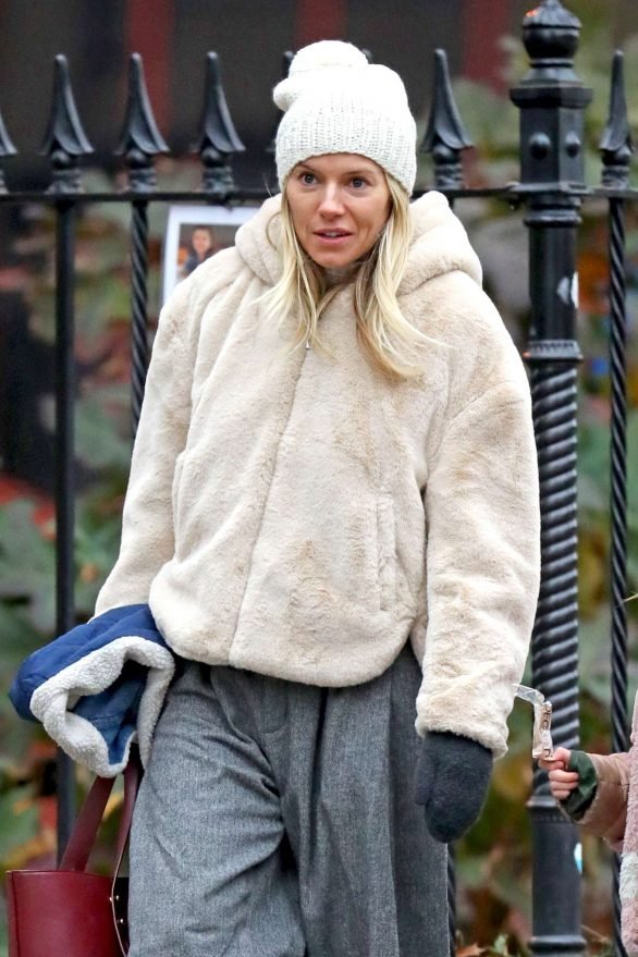 Sienna Miller - Wears a hooded fur coat out in NYC