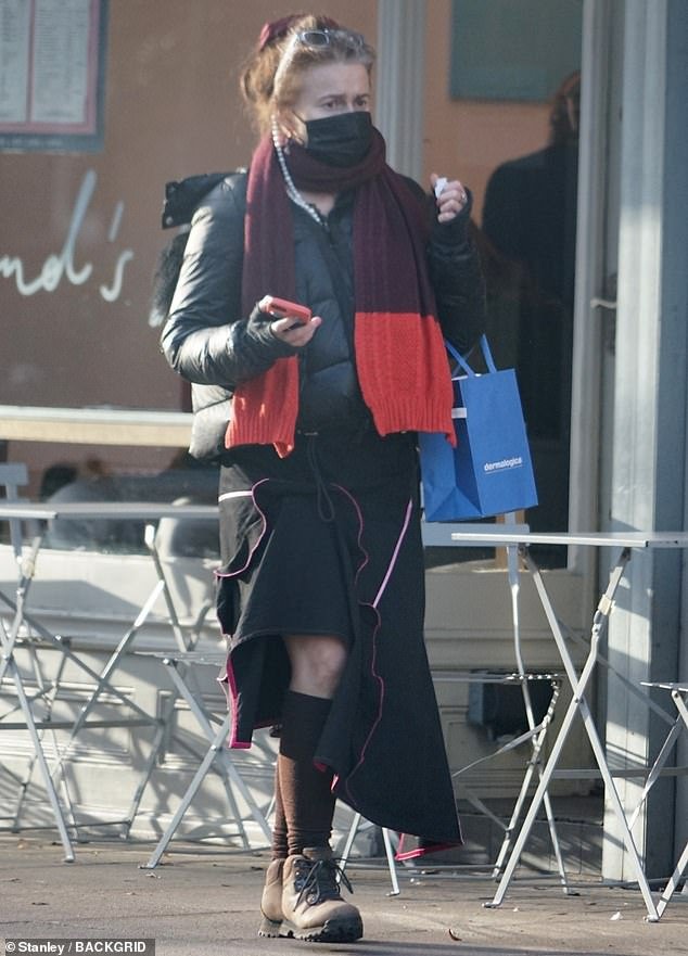 Casual: Helena teamed her low-key ensemble with long brown socks and chunky boots, while going make-up free and wearing a pair of sunglasses perched on her head