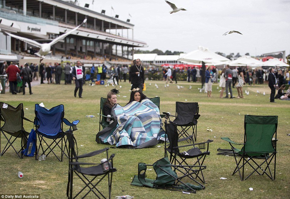 Draped in a blanket, these girls were some of the last remaining punters as Stakes Day drew to a close on Saturday