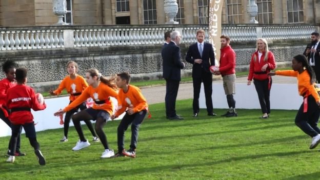 Prince Harry watching children play rugby