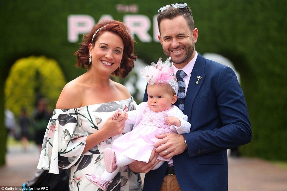 One couple looked thrilled to be taking their daughter to the famous Flemington racetrack for seemingly the first time