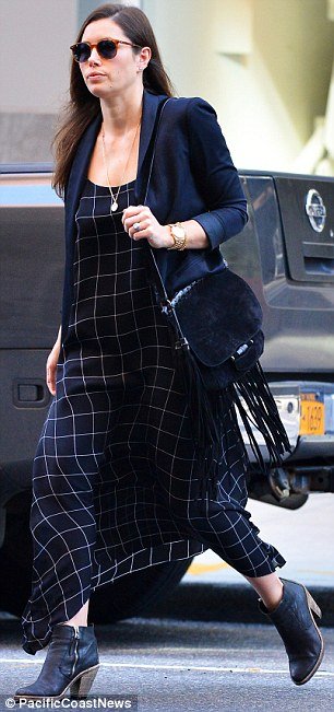 On the move: The 33-year-old, who chose a geometric patterned navy and white maxi dress, was spotted without her son, Silas, or husband of three years, Justin Timberlake