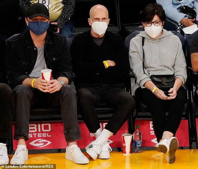 Friends: The actor, 47, cut a casual figure as he watched the NBA game with producer Jeffrey Katzenberg (middle), 71, and his wife Marilyn (right)