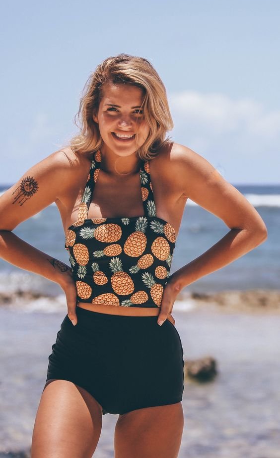 Pretty Pineapple Princess. Modest this modest two piece swimsuit from Beverly Swimwear. Black high waisted bikini bottoms with a long midkini top with adorable pineapples for the summer time: 