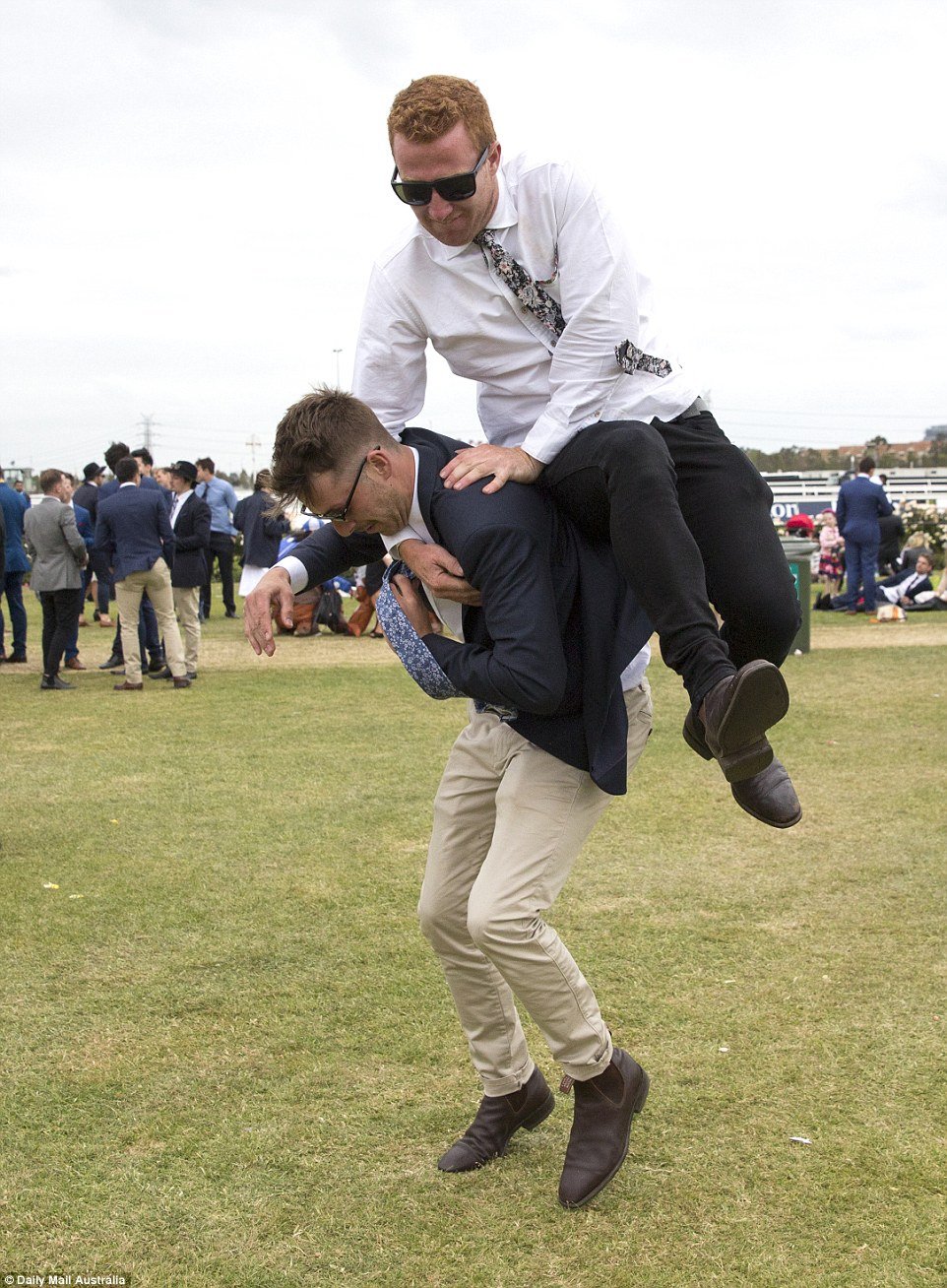 Using the full force of his body weight, one man is seen launching himself into the air and onto his unsuspecting mate