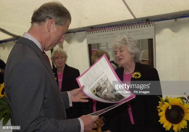 https://media.gettyimages.com/photos/the-prince-of-wales-looks-at-a-copy-of-the-famous-wi-calendar-girls-picture-id828793330?s=612x612